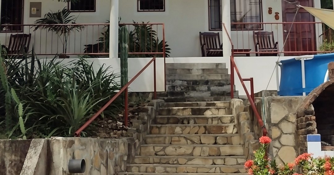 White villa with a stone staircase at Casa Todo Bueno